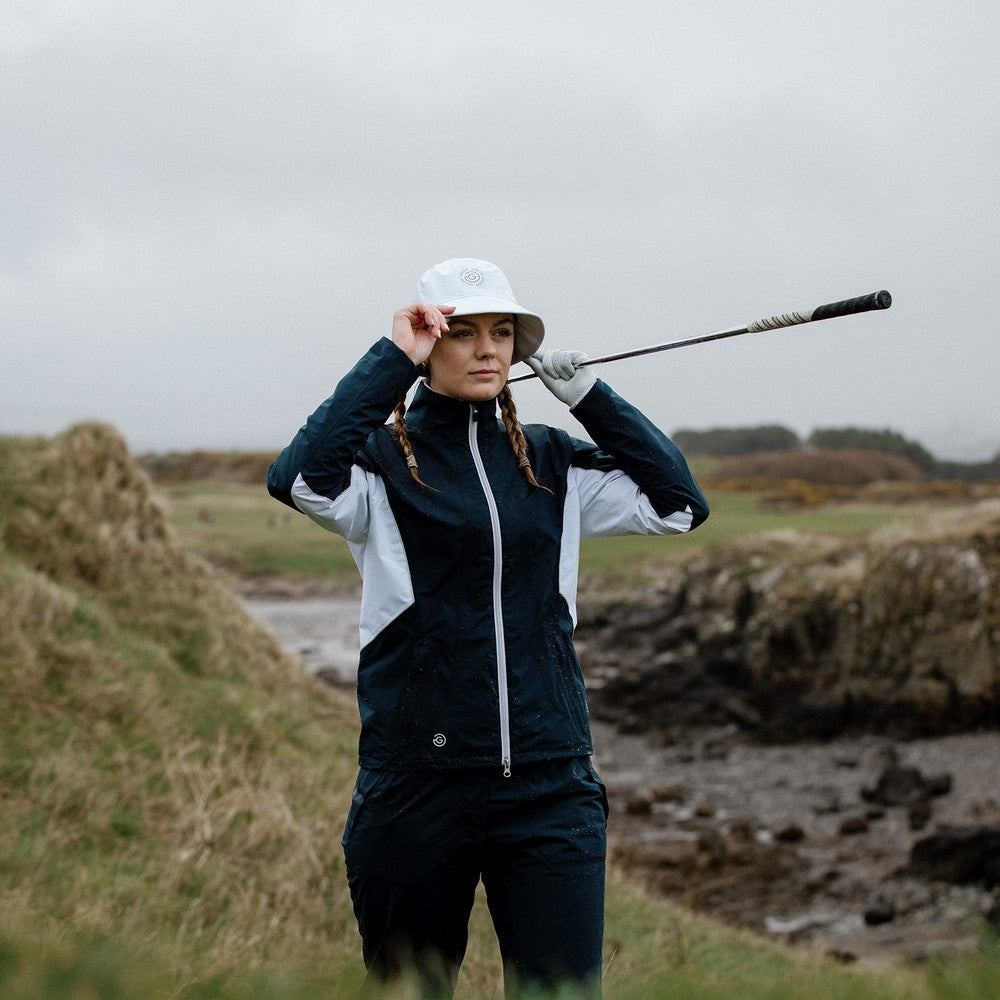 Golfer in a navy and white Galvin Green waterproof jacket from GolfGarb