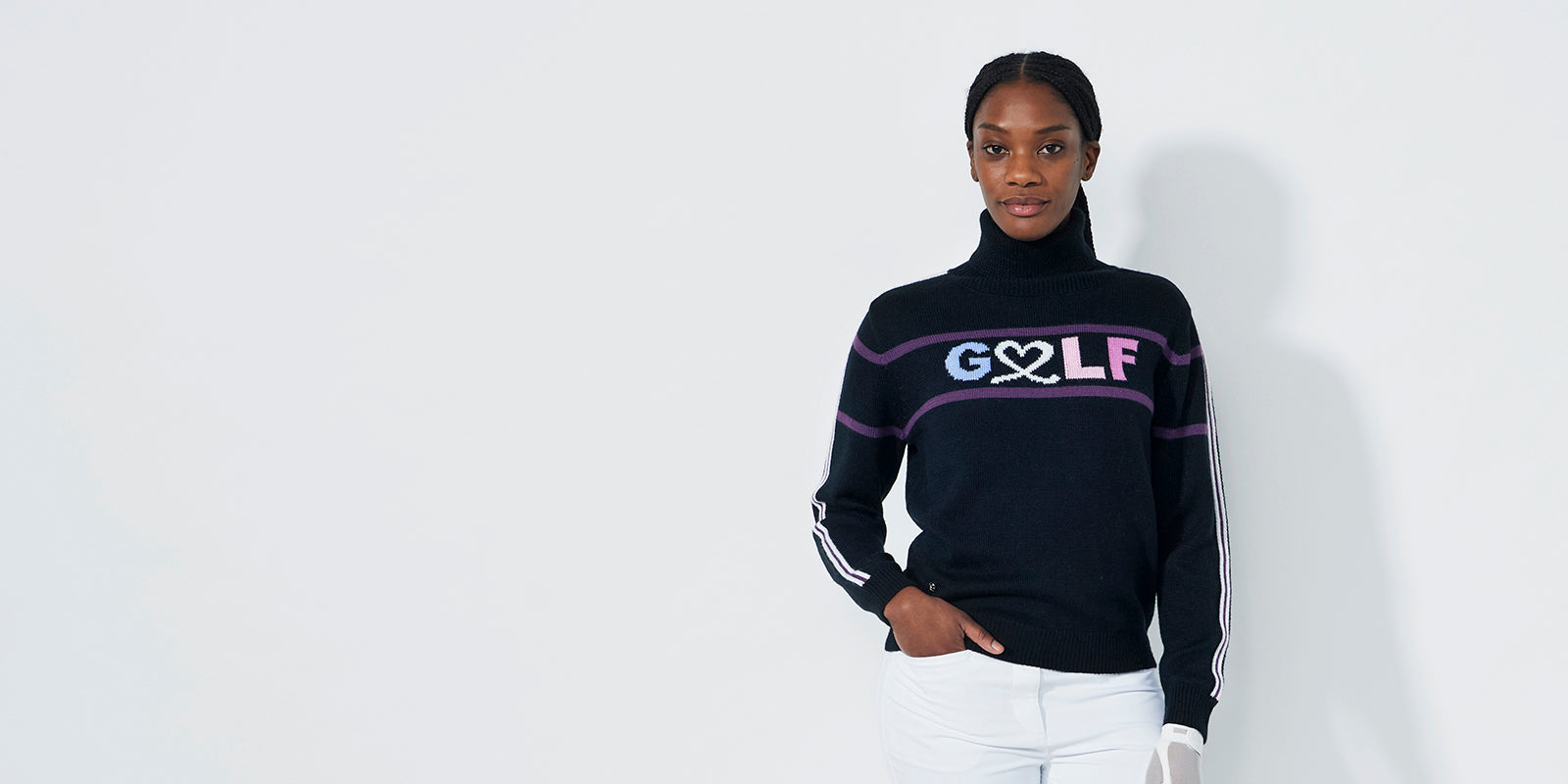 Model wearing a deep navy sweater from Daily Sports with 'GOLF' logo and a double stripe down the sleeves.