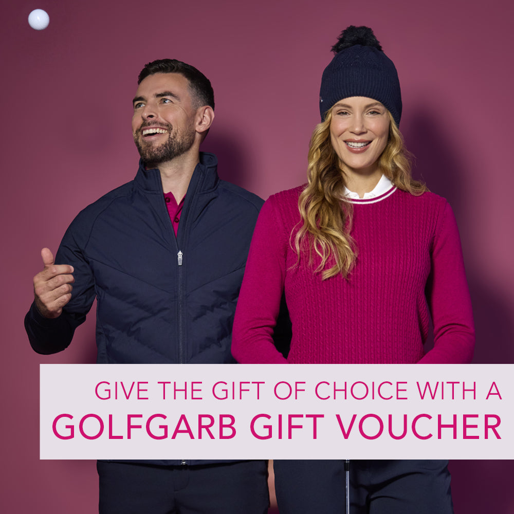 Image of a male and female model wearing Glenmuir 2026 golf clothing designs including the raspberry crew neck sweater, navy bobble hat and navy padded hybrid jacket. Copy reads "give the gift of choice with a GolfGarb gift voucher"
