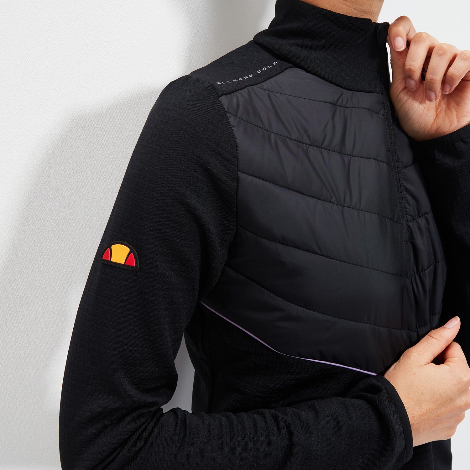 Ellesse Ladies Soft-Stretch Jacket with 1/4 Zip Neck and Quilted Panels in Black